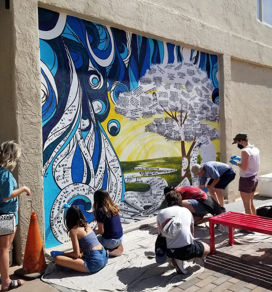 community involvement with mural painted their names and favorite literay quotes scaled e1688400134672